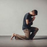 Man in his knees praying