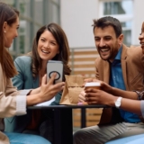 Group,Of,Happy,Entrepreneurs,Watching,Something,Funny,On,Cell,Phone