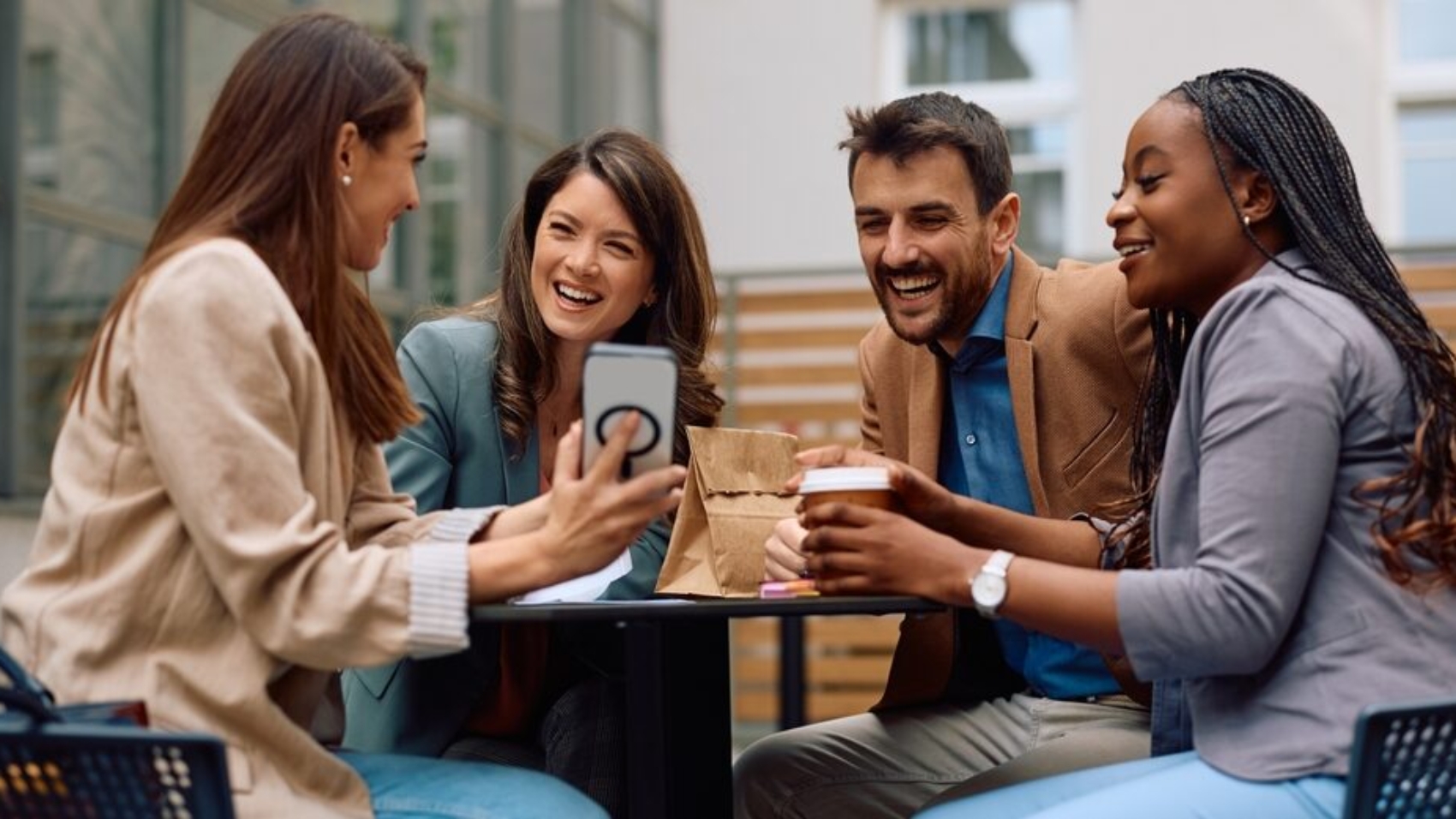 Group,Of,Happy,Entrepreneurs,Watching,Something,Funny,On,Cell,Phone