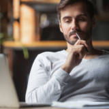 Pensive,Bearded,Man,Sitting,At,Table,Drink,Coffee,Work,At